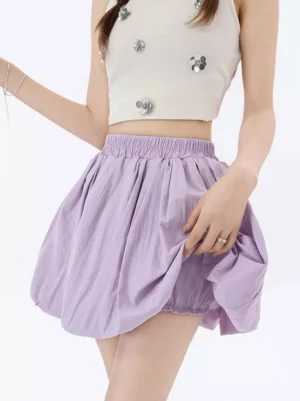 Lavender pastel bubble mini skirt with elastic waist and gathered hem, featuring soft wrinkled polyester fabric and built-in bloomers, styled with cropped white tank top for sweet lolita aesthetic