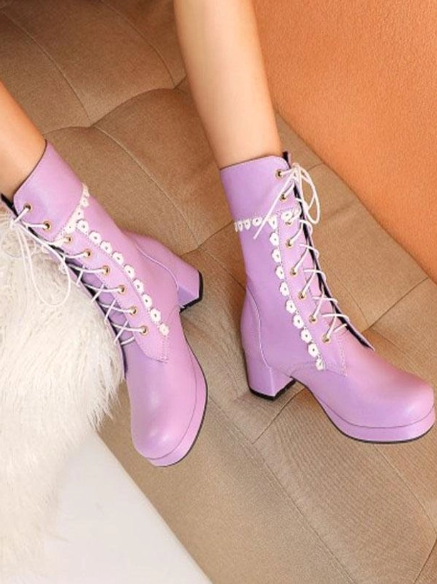 Lavender PU leather lace-up Lolita boots with round toe and block heel featuring white floral lace trim, worn on model's feet on beige sofa