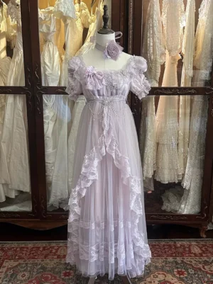 Lavender lolita dress full front view showing empire waist beaded sash and layered lace ruffles on mannequin