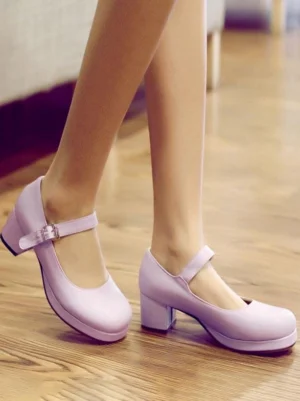 Lavender light purple Lolita Mary Jane pumps tilted on-foot side view displaying adjustable ankle strap buckle, closed round toe design, and thick block heel on wooden floor