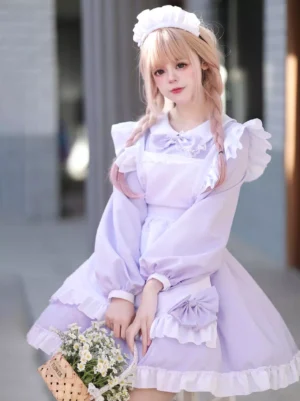 Lavender sweet maid lolita mini dress with ruffled apron and bow details worn by blonde model in outdoor street setting