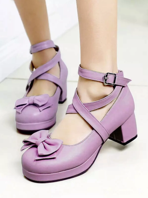 Lavender purple Sweet Lolita platform shoes with round toe, front bow embellishment and cross ankle straps close-up front view on-foot display
