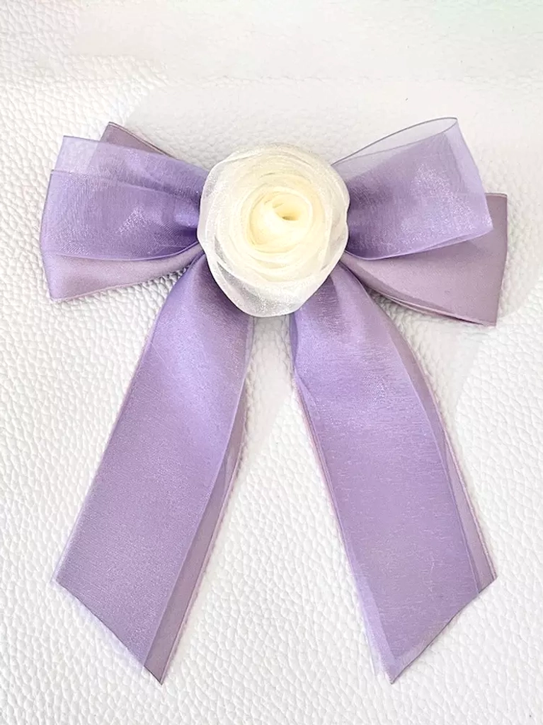Lavender purple sheer organza bow hair clip with cream rose embellishment, flat lay front view on white textured background, mystical sweet lolita hair accessory