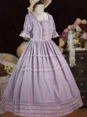 Three-quarter front view of lavender sweet lolita dress showing lace accented bodice ruffled short sleeves and structured silhouette with straw hat