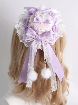 Sweet Lolita lavender mini top hat hair clip rear view with pearl chains heart gem and fluffy pom-pom pendants on mannequin