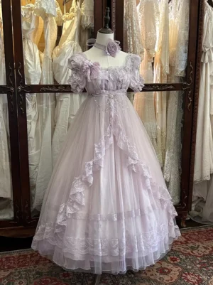 Lavender Sweet Lolita princess dress front three-quarter view with ruffled puff sleeves and decorative neck flower on dress form