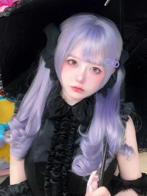 Lavender twin curly lolita wig front close-up worn by model in gothic lolita dress with air bangs and black decorative hair bows
