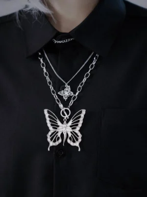 Double layered butterfly necklace close-up on model, silver metal hollow butterfly charms, two different sizes, black collared shirt, front view lolita accessories