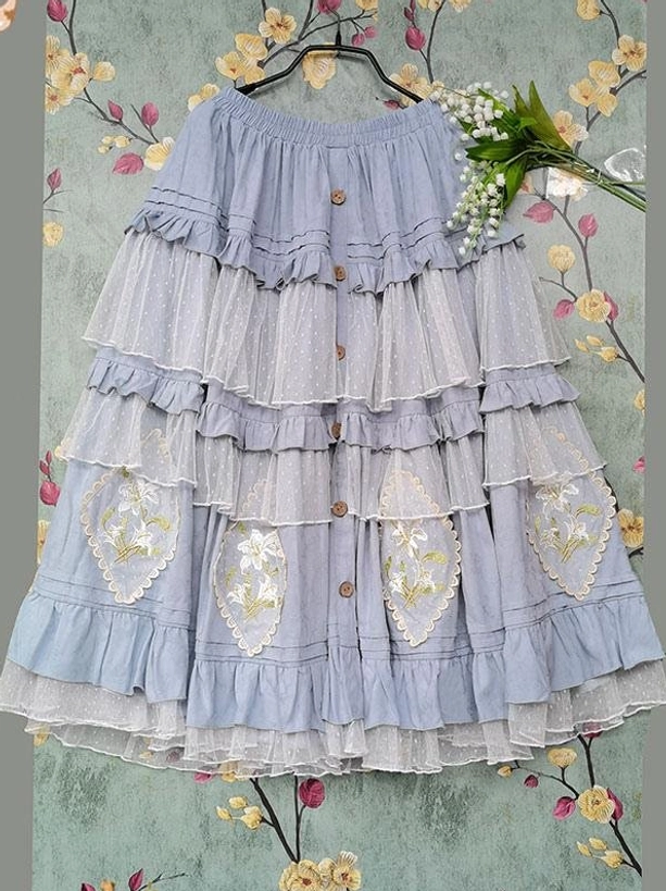 Light blue off-shoulder tiered Classic Lolita dress flat lay hanging view with front button decorations and heart-shaped floral embroidery layered tulle ruffled skirt