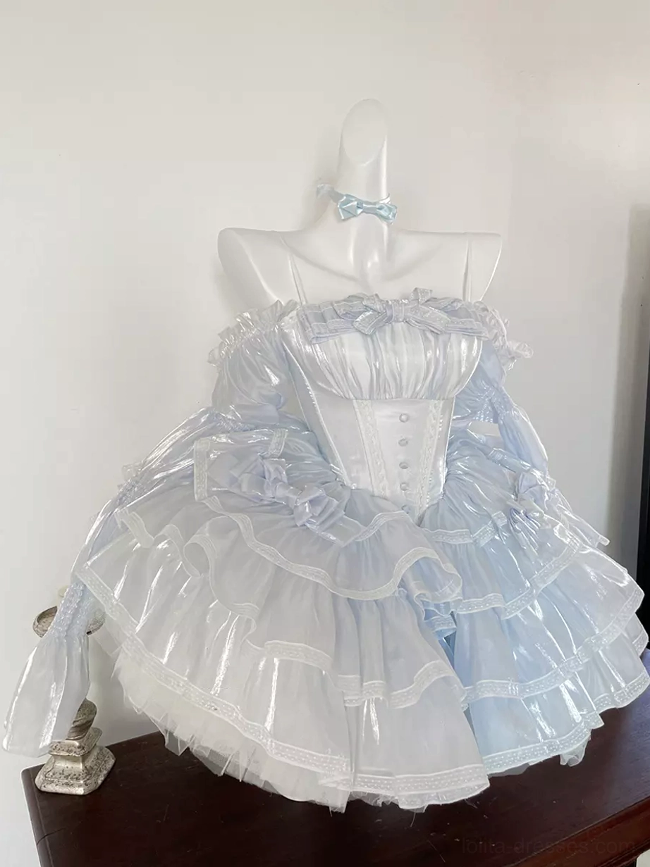 Light blue lolita dress tabletop display showcasing strapless structured corset top, shiny tiered ruffle skirt, small blue bow choker, and refined silhouette