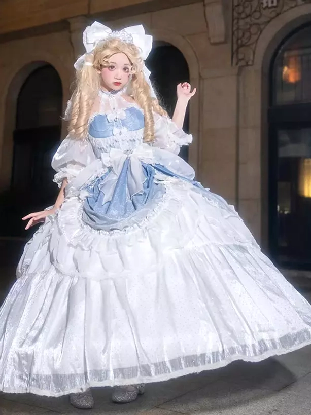 Enchanted fairy Lolita princess dress in light blue with white bow neckline, layered ruffled skirt, and romantic puff sleeve design