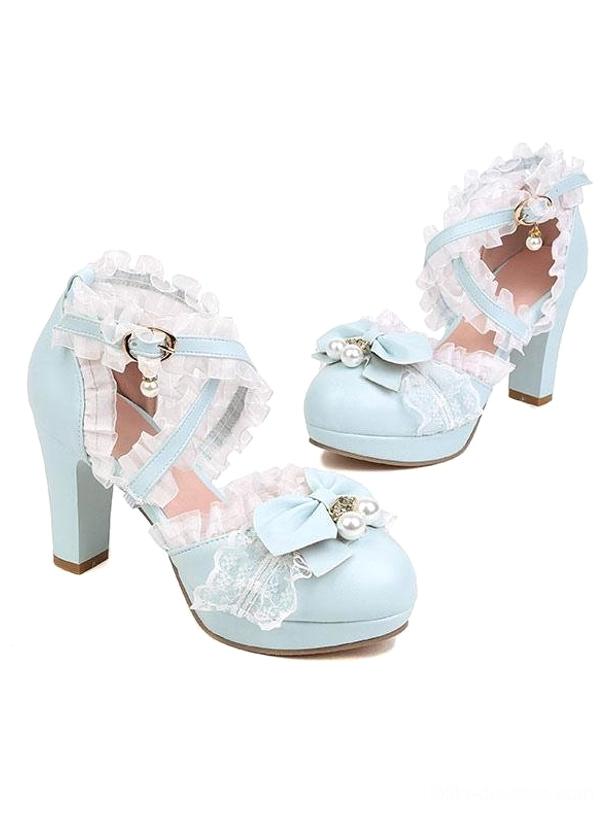 Pair of light blue Lolita pumps overhead flat lay view showing ruffled straps bow pearl decoration block heel rococo style design