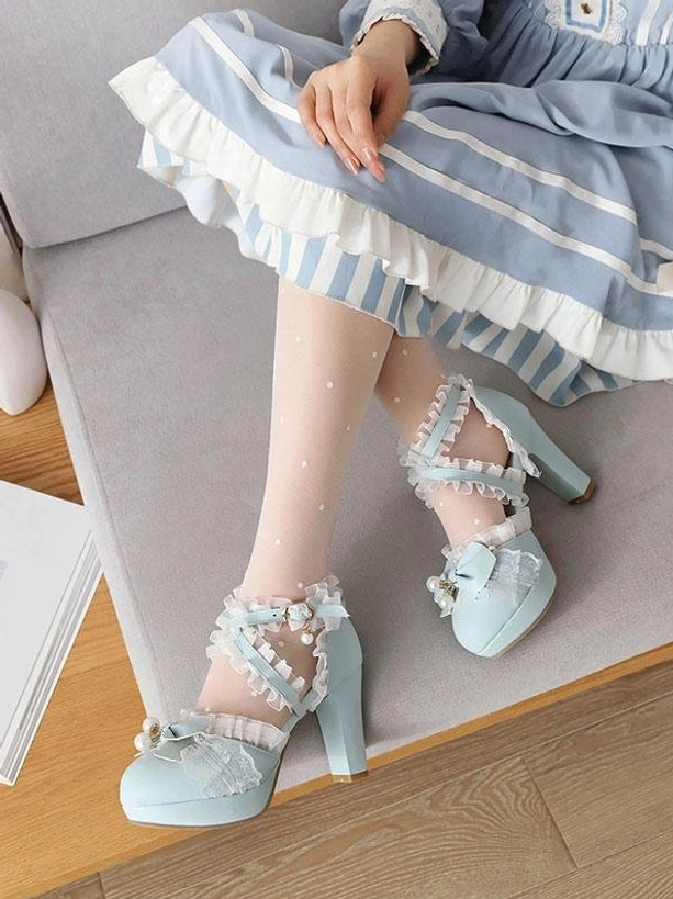 Light blue Lolita pumps with ruffled straps bow and pearl embellishments round toe on sofa worn with blue-white striped dress