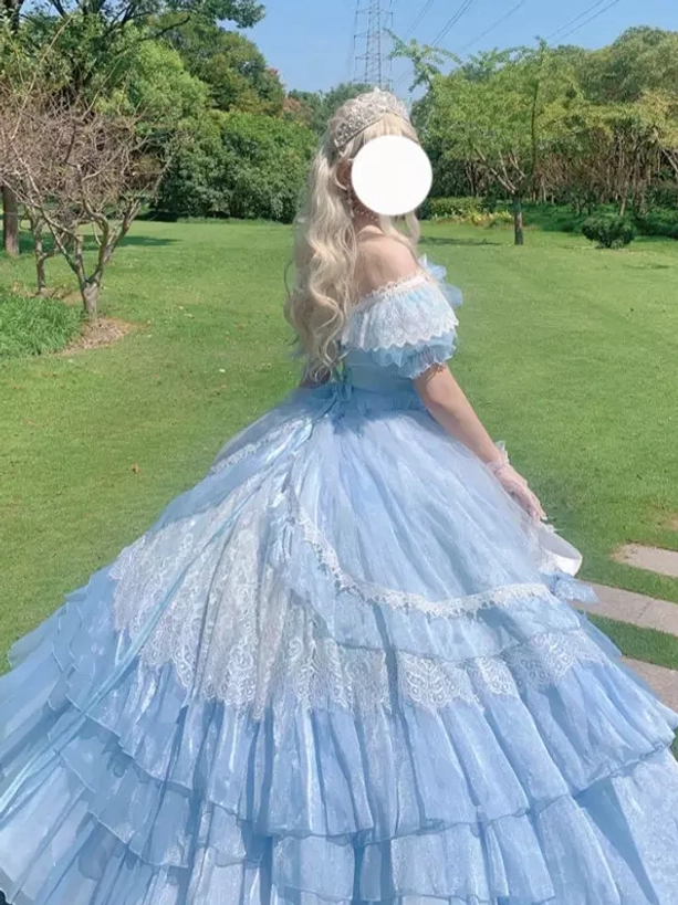Light blue off-shoulder Lolita fairy gown back three-quarter view featuring layered lace-trimmed skirt, romantic puff sleeves, and voluminous ball gown silhouette