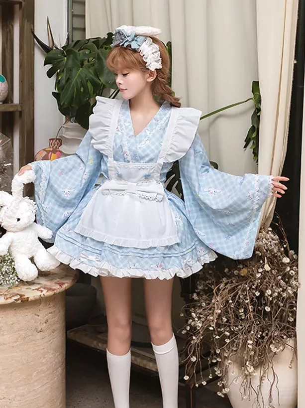 Side three-quarter profile of sky blue lolita kimono dress showing wide flared long sleeves model with arms spread matching hair accessory and white knee-high socks