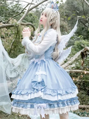 Light sky blue sleeveless sweet lolita dress with angel wing accessory and two-tone ruffled hem, shown in three-quarter side view with bow bust decorations and forest background