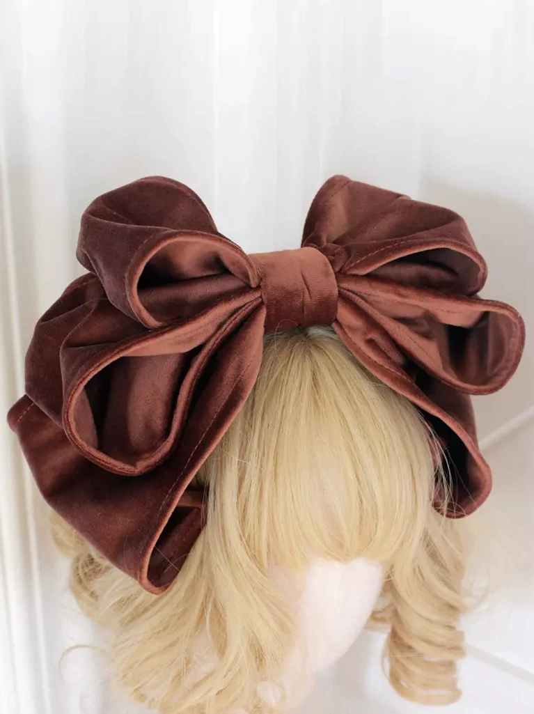 Light brown caramel velvet Lolita bow headdress with dimensional double-layer construction displayed on blonde mannequin against plain white wall, highlighting color and texture clarity
