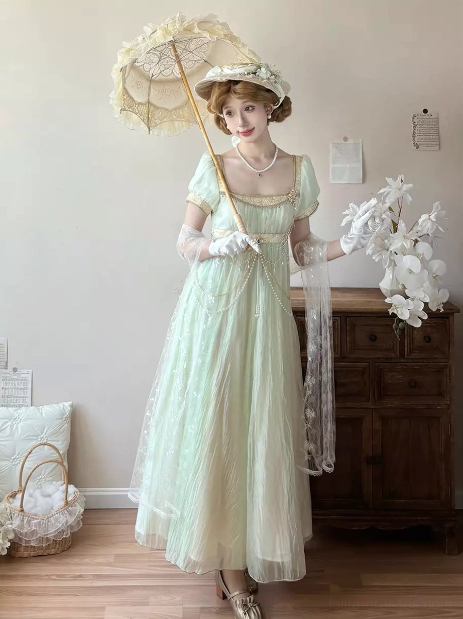 Light gold Regency Lolita ball gown full-length view showcasing empire waist, chain details, puff sleeves, and romantic champagne-tone sweet Lolita aesthetic