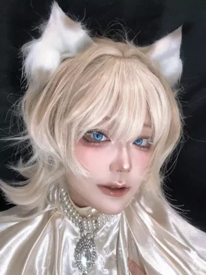 Light gold ouji lolita wig with fluffy white cat ears worn by cosplayer with blue contact lenses, front close-up headshot showcasing tousled layered short blonde hair and cute feline details
