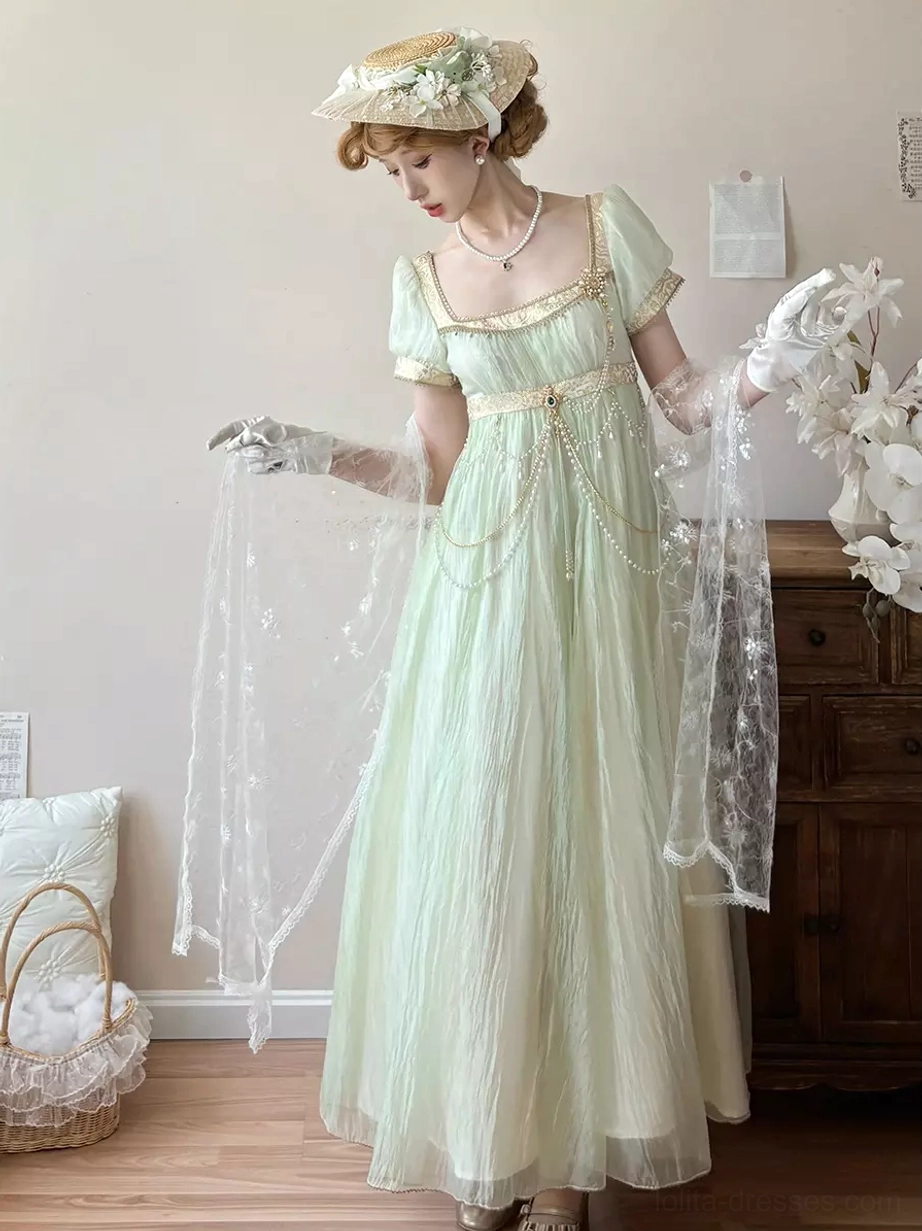 Champagne-tone Regency Lolita ball gown detail view showing puff sleeve volume, empire waist lines, chain embellishments, romantic sweet Lolita silhouette