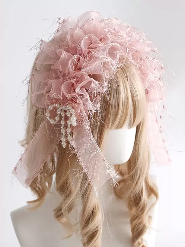 Light pink sweet lolita headdress with delicate frayed organza ruffles, pearl bow trim, and sheer side ribbons worn on mannequin, three-quarter perspective showcasing romantic details