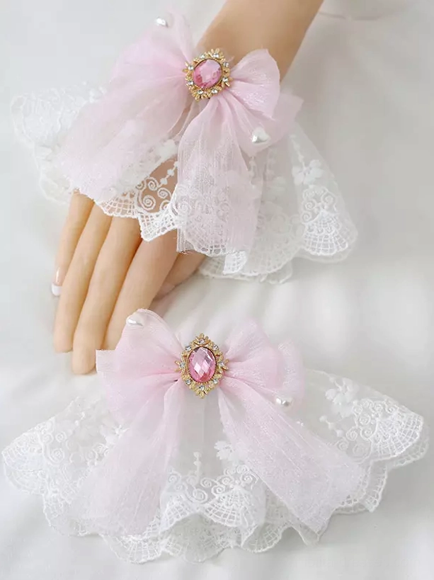 Light pink organza wrist bow lolita accessory with pink gemstone in gold frame and subtle pearl-accented ruffled lace foundation