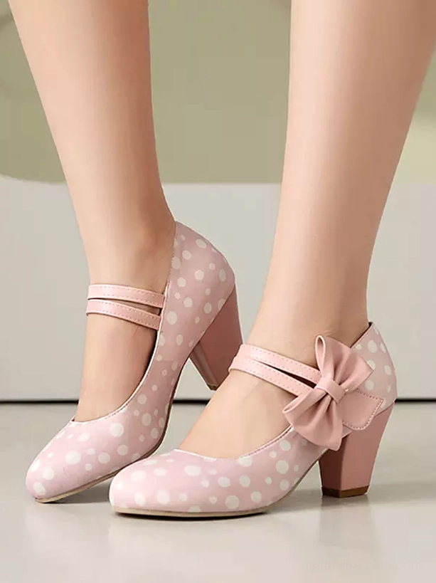 Light pink and white polka dot Mary Jane lolita heels with pink bow detail on model - front lower leg shot