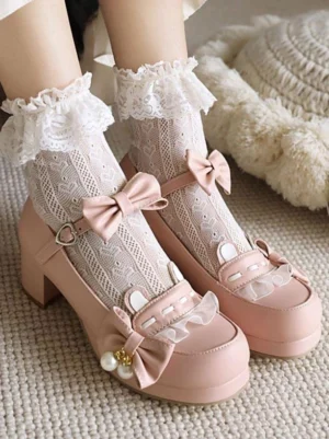 Light pink sweet lolita high heel Mary Jane shoes worn with frilly white lace socks featuring bow decoration, showcasing pearl charm bow detail