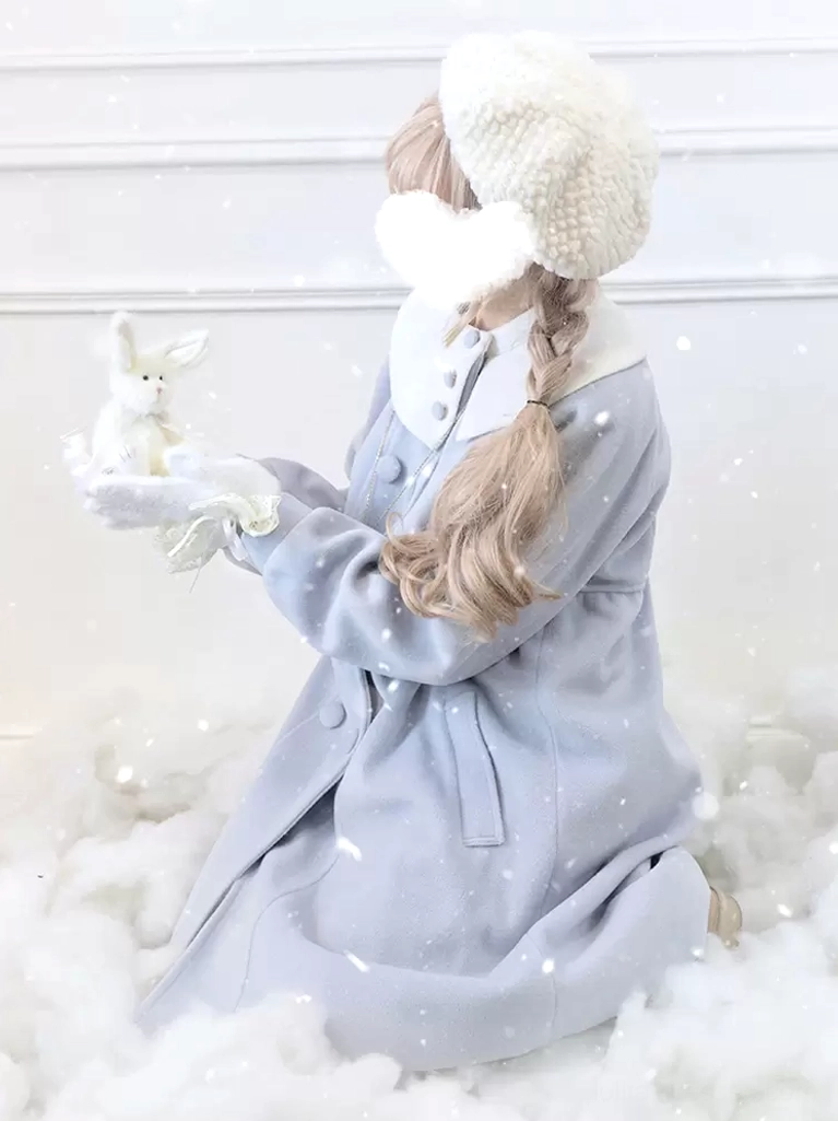 Light sky blue lolita overcoat back sitting view with contrast collar, long sleeves, fuzzy white hat and plush rabbit ornament accessory