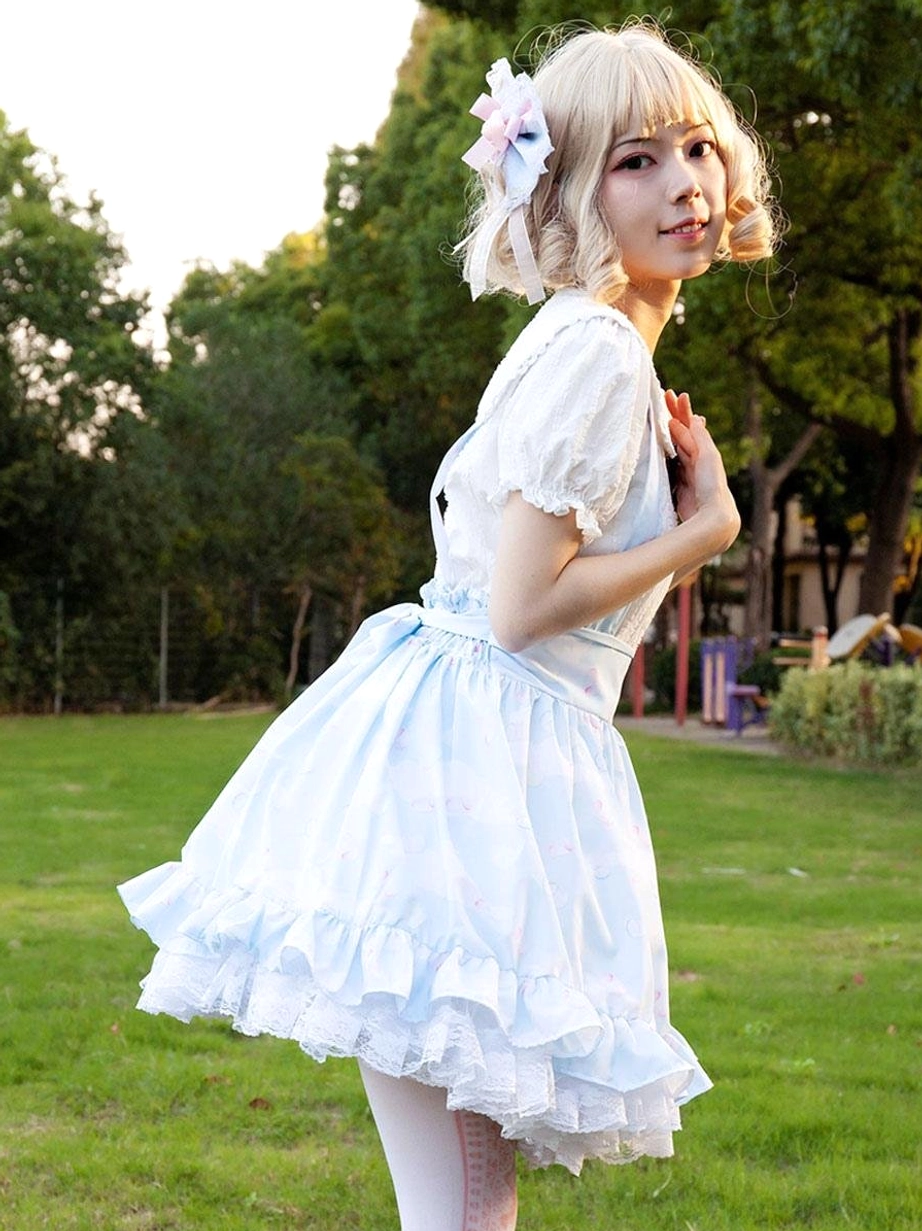 Side three-quarter view of light sky blue lolita skirt with ruffled lace details and fitted waist, paired with white peter pan collar blouse, pastoral style coordination