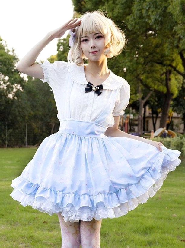 Light sky blue pastoral lolita skirt with delicate floral print and cascading ruffled hem, front full-body view worn with white blouse and black bow collar accent, outdoor park setting