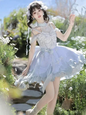 Light sky blue sweet lolita fairy dress with butterfly embroidery worn outdoors in flower field three-quarter view showing off-shoulder halter neck beaded bodice and layered ombré ruffled skirt