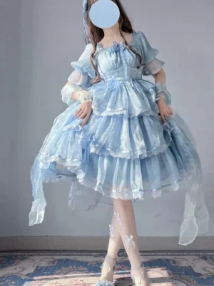 Light sky blue sweet lolita fairy dress with tulle layers and puff sleeves full body front view on model wearing matching accessories