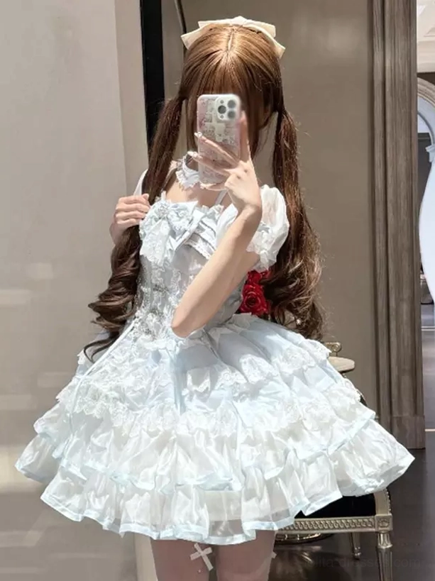 Light sky blue sweet lolita JSK dress with tiered ruffle satin skirt front three-quarter mirror view featuring faux corset bodice and short puff sleeves