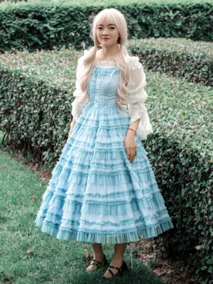Light sky blue sweet lolita JSK dress with white puff-sleeve blouse front full-body view garden setting tiered ruffle midi skirt