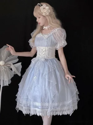 Light sky blue Sweet Lolita princess dress side view featuring sheer ruffled puff sleeves, lace-trimmed hem, and structured corset waistband worn by blonde model with floral hair ornament