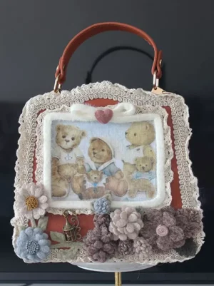 Sweet lolita handbag brown top handle red side panels heart-shaped bow teddy bear print flat front view white stand