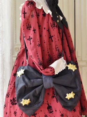 Lolita celestial crossbody bag with pearl-trimmed ruffled top and 3D gold star ornaments paired with red lolita dress right side angle