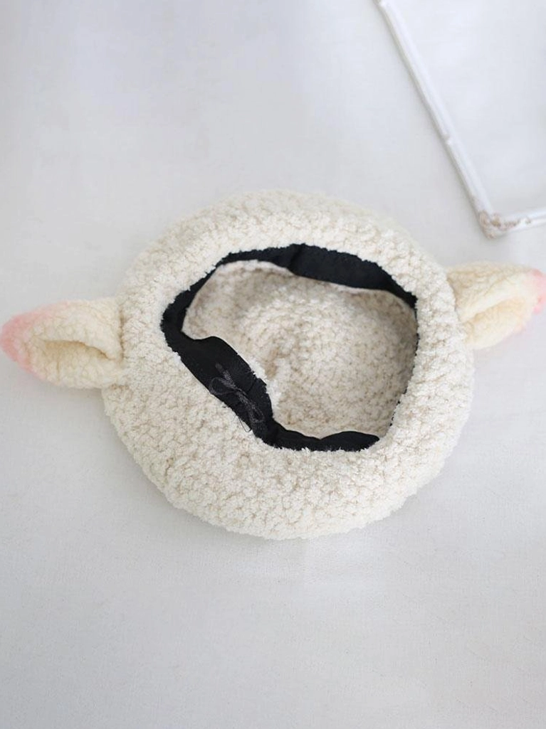 Interior detail of adjustable black elastic strap on off-white plush lolita beret with pink-tipped sheep ears, cute lolita hat inner construction and sizing mechanism