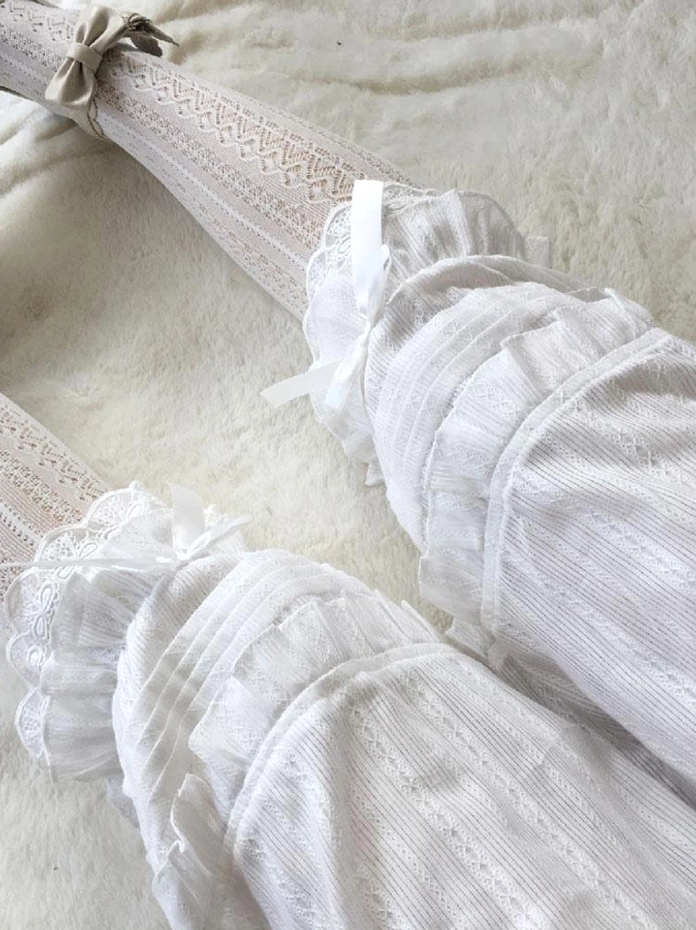 Close-up detail of lolita bloomer cuffs with satin bows paired with matching beige lace ankle socks, showcasing coordinated sweet lolita styling aesthetic