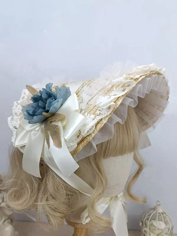 Blue floral rococo lolita bonnet with ivory satin bow and intricate lace details - side view on mannequin
