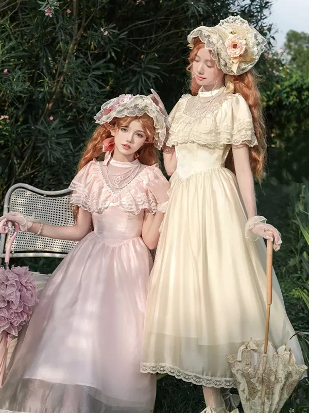 Vintage Lolita bonnet with flower decorations and pearl chokers worn with elegant dress and rattan chair garden backdrop