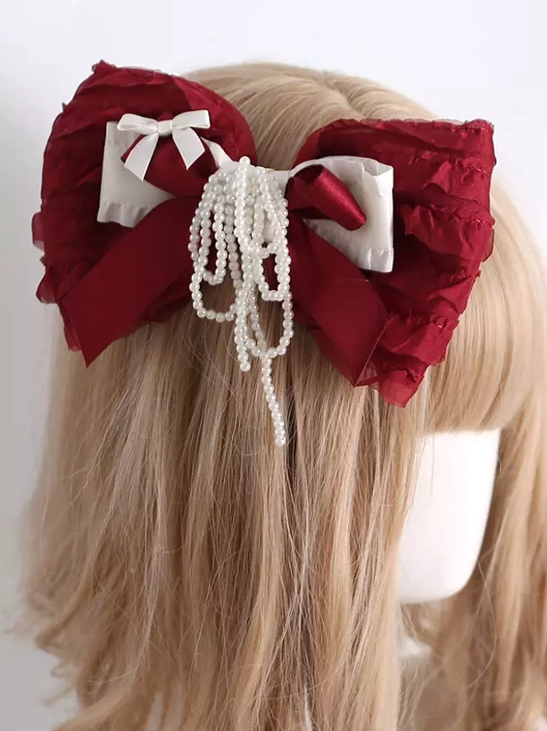 Lolita hair clip headdress back view on mannequin showing wine red bow and long hanging pearl tassel with light brown long wig