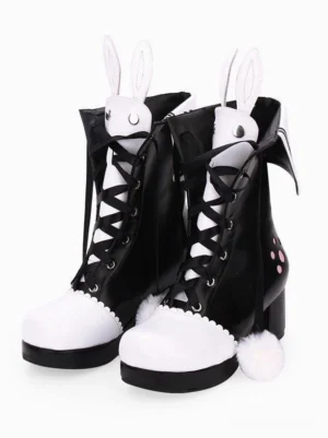 Black and white two-tone lolita bunny ear boots with pink paw prints and lace-up front, front three-quarter view