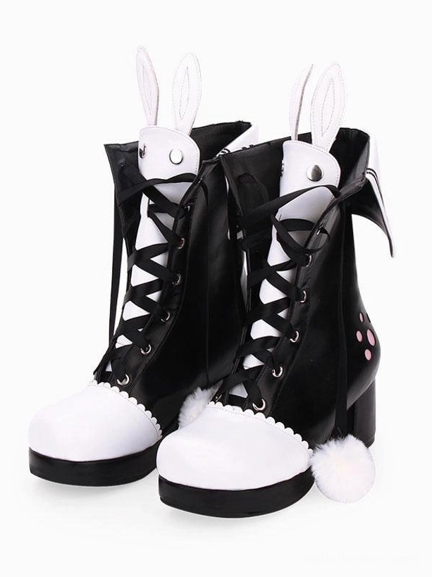 Black and white two-tone lolita bunny ear boots with pink paw prints and lace-up front, front three-quarter view