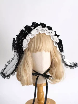 Double-layer ruffled Lolita headband with embroidered lace ear panels and polka dot ribbon decorations, direct front view