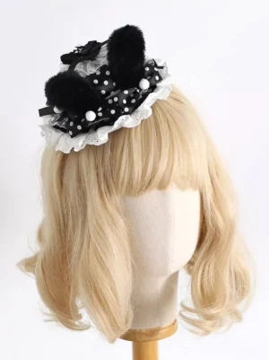 Lolita bunny ear headdress showing delicate lace trim details, polka dot ribbon, black plush ears, and white pom-pom decorations front angle view