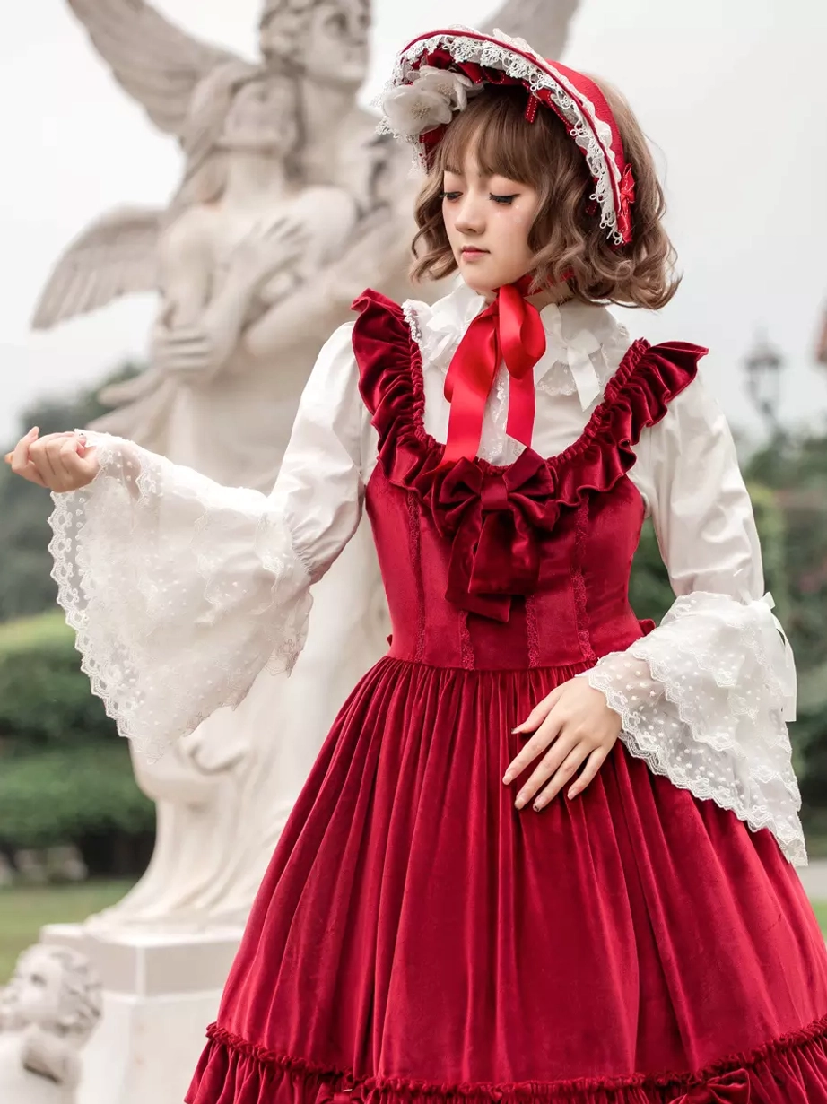 Sweet lolita burgundy JSK dress side three-quarter view showing ruffled shoulder straps and sleeveless design with lace bonnet and white inner blouse