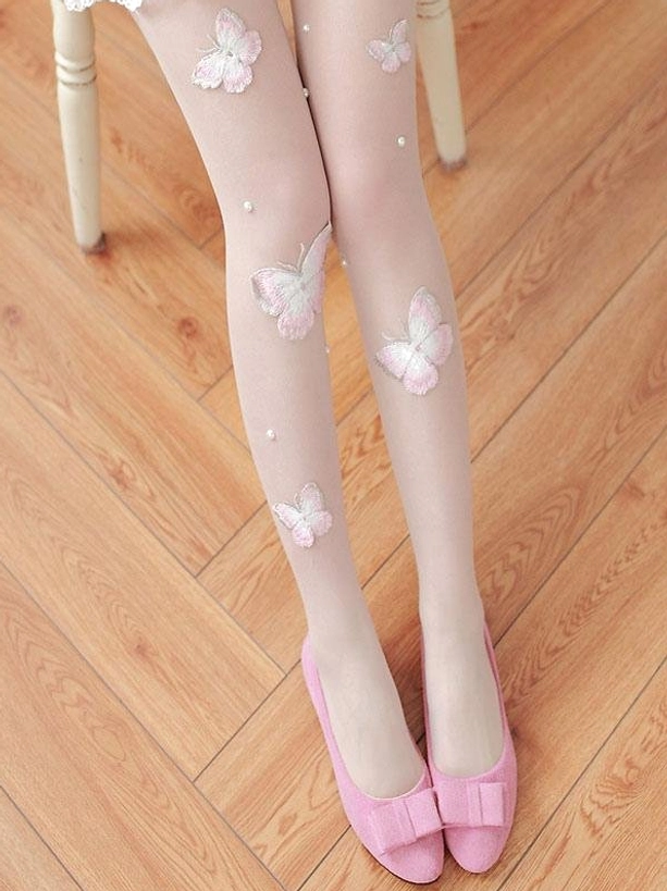 Front full-length view of Lolita butterfly embroidered nude stockings paired with pink bow flat shoes on wooden floor, complete outfit styling display