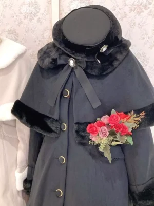 Dark grey Lolita winter cape coat close-up detail showing faux fur collar trim, jeweled bow brooch, and matching round hat accessory